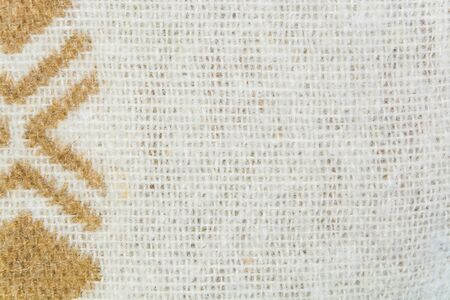 The texture of white woolen yarns twisted with brown ornament closeup