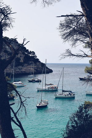Boats moored on the beach of Trebaluger in Menorca in Spain on August 6, 2021