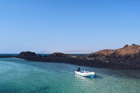 small boat anchored on the island of Lobos in Fuerteventura in Spain, on August 11, 2017のeditorial素材