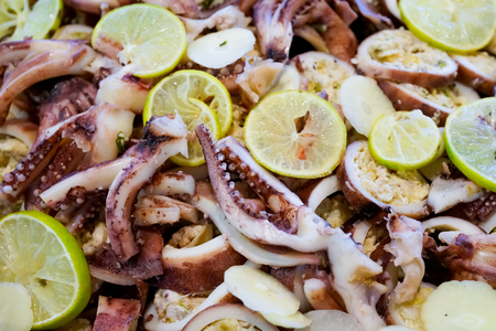 Close up of thai spicy squid salad with lemon, garlic and herb