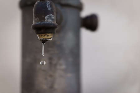 Closed up selective focus of Vintage water faucet with droplet, as water saving concept.の写真素材