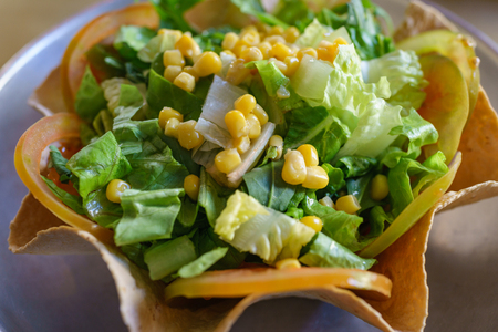 Healthy green vegetable salad with corn and tomato on crispy italian wontons.の写真素材