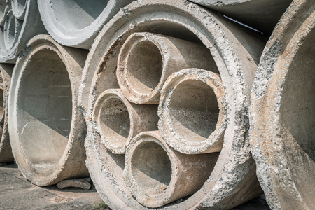 Stack of concrete drainage pipes prepare for underground construction.
