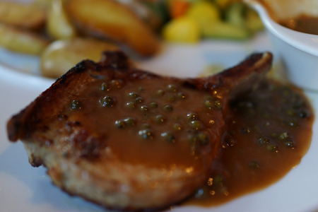 Selective focus of beef steak with green peppers.の写真素材