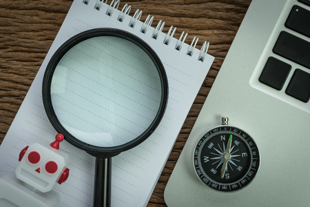 SEO search engine optimization website analysis concept with pencil, compass, computer and magnifying glass in flat lay.の写真素材