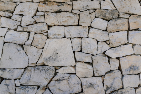 rustic ancient handcraft tile stack stone wall as background in Italy.の写真素材