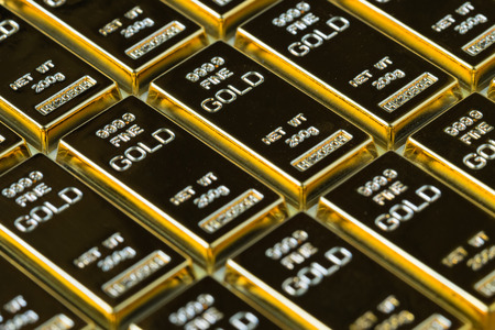 closed up shot stack of shiny gold bars as business or financial investment and wealth concept.の写真素材
