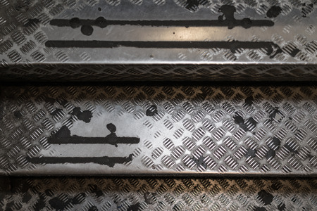Old aged used steel stair case ladder with pattern texture.の写真素材
