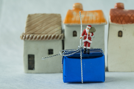 miniature figure Santa claus standing on big present box as christmas celebration concept.の写真素材
