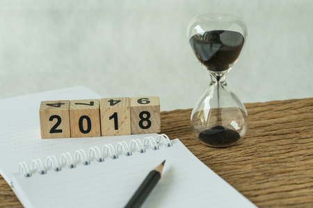 Happy new year 2018 goals, target or checklist concept as number 2018 wooden cube block with...
