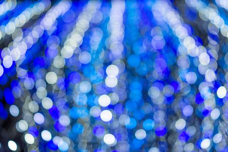 Blue and white abstract bokeh like snow from the sky using for christmas festive celebrate, wallpaper or background.の写真素材
