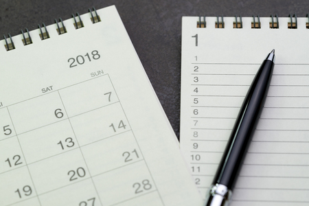 Year 2018 to do list concept by notepad with list number and pen on calendar.の写真素材