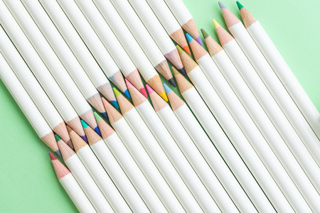 Children coloring equipment, pastel pencils color arrange on pale green paper background using as education or art concept.の写真素材