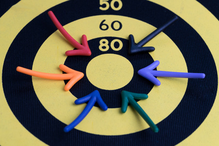 Business success target concept, multi colorful magnet arrows pointing at center score of yellow...