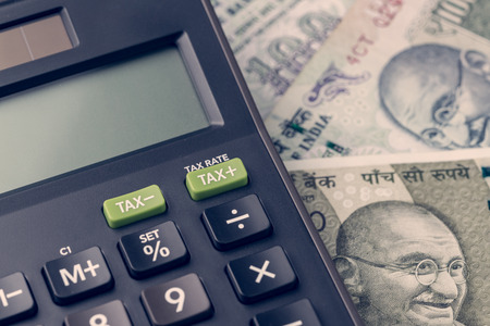 India financial, new emerging market high growth country concept, closed up of calculator on indian rupee banknotes on table.の写真素材