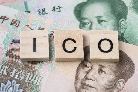 ICO initial coin offering crypto currency banned in China concept, with wooden block with alphabets...