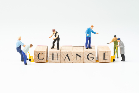 Business change, transform or self development for success concept, miniature people figure, workers, employee staffs help move wooden stamp block to arrange the word CHANGE on white background.の写真素材