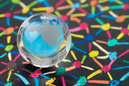 Globalization, social network or connectivity world concept, small decoration globe with colorful pastel link and connect chalk line between multiple dots or tiers on blackboard.の写真素材