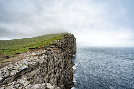 Amazing view of slave mountains of Tralanipan steep cliff in Vagar island, Faroe Islands, Denmark north Atlantic ocean, best destination for hiking, stunning sea stack with deep blue water.の写真素材