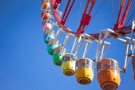 Amazing colorful ferris wheel in amusement park with sunshine blue sky in the morning with copy space, can be used as optimistic or start new day with happiness concept.の写真素材