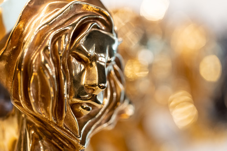 Closed up of gold Cannes lion award, trophy for winner of advertising agency in yearly festival in Cannes, France.の写真素材