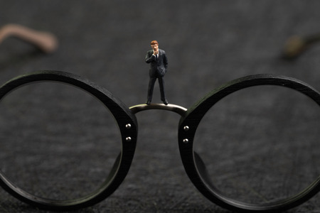 Business vision, professional thinking to see solution for problems, miniature businessman with suit...