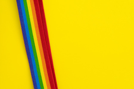 LGBT rainbow headband on solid yellow background with copy space using as celebrate of homosexual,...