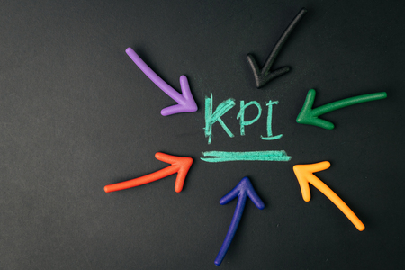 KPI, Key Performance Indicator, metrics to measure business success or marketing campaign goal and target achievement, arrow pointing to handwriting chalk word KPI in pastel green on blackboard.の写真素材