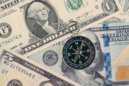 FED, Federal Reserve of US government direction on interest rate concept, compass on US Dollar banknote with Feral Reserve emblem.の写真素材
