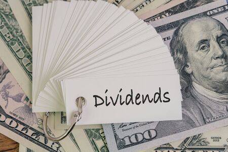 Dividends, return or earning that pay from stock or mutual fund investing concept, lot of paper...