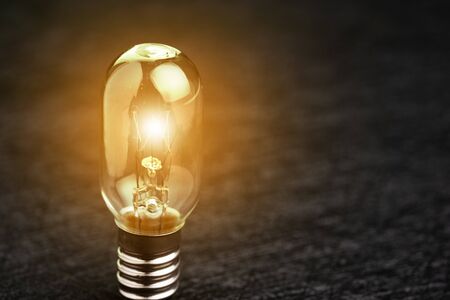 Business idea, creativity or thinking about product and service, illuminated small light bulb on...