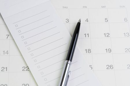Pen on checklist with checkbox notepad on clean calendar using as special event, planner, important reminder or appointment list concept.の写真素材