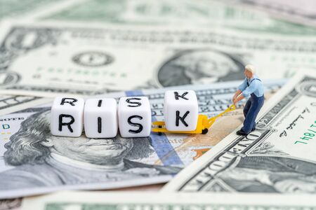 Investment risk in stock market or financial assets concept, miniature people man pulling forklift...