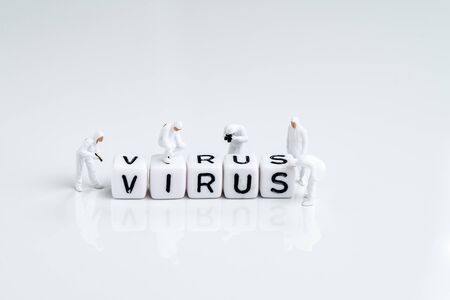 Miniature people inspector team with protective suit inspecting cube block combine the word Virus...