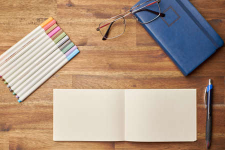 Background with notebook and colors pensの写真素材