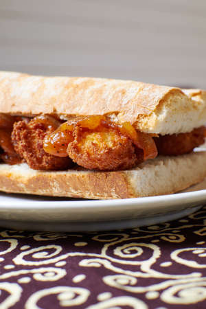 Breakfast sandwich with meat and onion in a plate with backgroundの写真素材