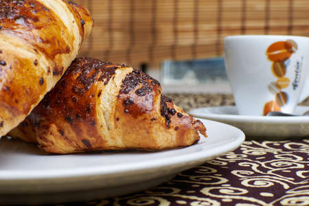 Chocolate croissants with coffee breakfast backgroundの写真素材