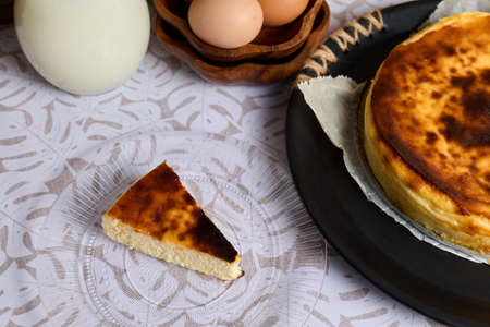 A creamy cheesecake with eggs and milk on white backgroundの写真素材