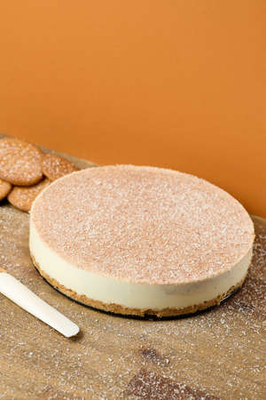 Dark and white chocolate cake with cookies on orange backgroundの写真素材
