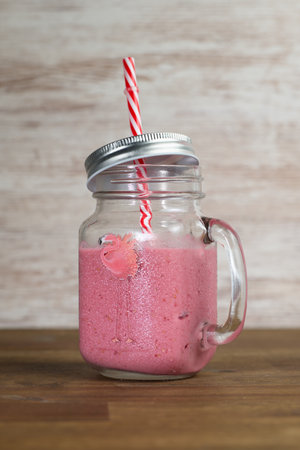 Fresh healthy fruit smoothie on a clear wooden backgroundの写真素材