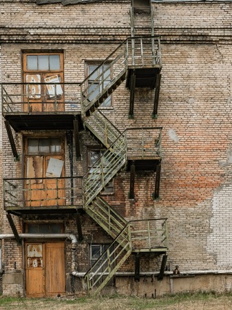 Old rusty fire escape on an abandoned industrial buildingの写真素材