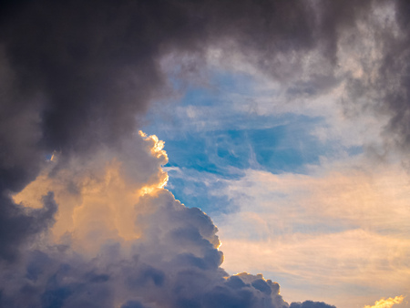 Heavy thunderclouds, illuminated from the inside by orange sunlight. Dramatic picture of nature.の写真素材