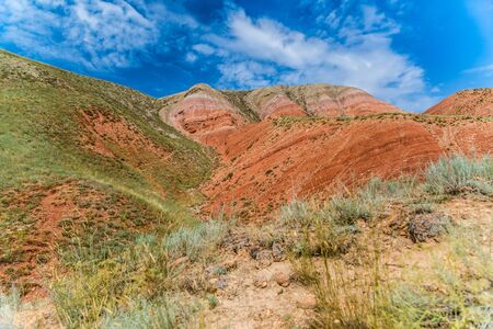 View of the bright red sandy-clayey slopes of the mountain Big Bogdo.の写真素材