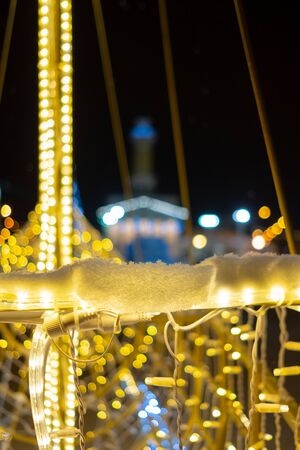 A fragment of Christmas LED illumination at night on a city street. Abstract blurred background. Good New Year spiritの写真素材