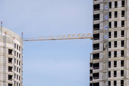 Moscow. Russia. September 06, 2020 View of the construction of a modern monolithic house against the background of the sky. Tower cranes in the construction of a high-rise apartment buildingのeditorial素材