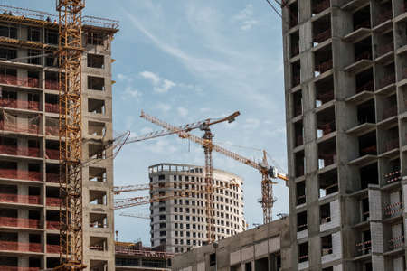 Moscow. Russia. September 06, 2020 View of the construction of a modern monolithic house against the background of the sky. Tower cranes in the construction of a high-rise apartment buildingのeditorial素材