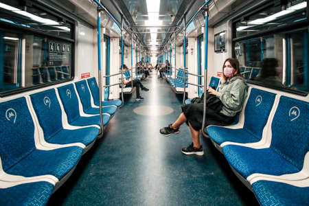 Moscow. Russia. August 29, 2020 The interior of a half-empty Moscow metro car. Passengers in protective masks. Necessary measures to protect against coronavirus infectionのeditorial素材