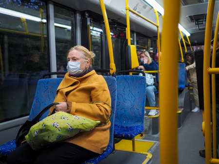 Moscow. Russia. September 14, 2020. Elderly women inside a city bus. On the faces of passengers are protective masks. Prevention measures against virus infection. Social distance in public transport.のeditorial素材