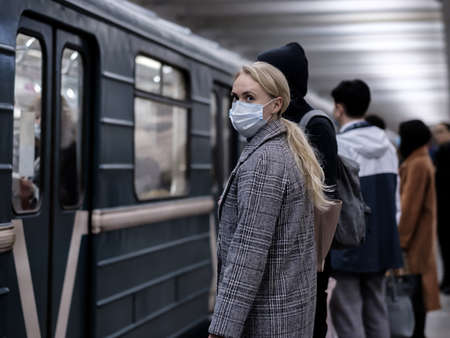 Moscow. Russia. September 28, 2020 A young woman wearing a protective medical mask stands on the...