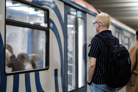 Moscow. Russia. September 25, 2020. A man in a protective medical mask stands on the platform of a...